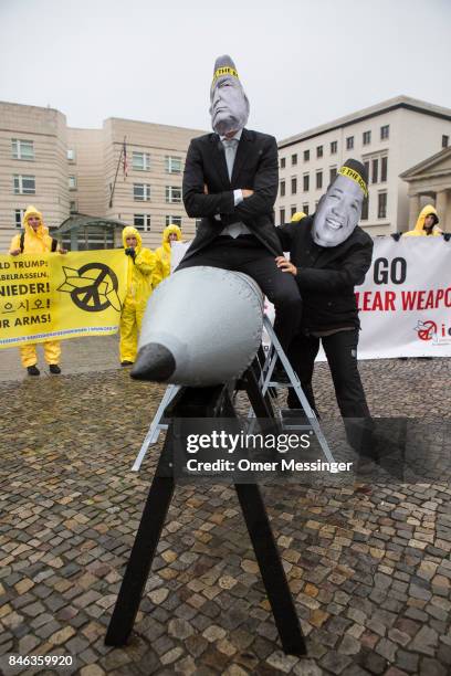 International campaign to abolish Nuclear Weapons activists wearing masks to look like US President Donald Trump and North Korean Kim Jong-Un pose...