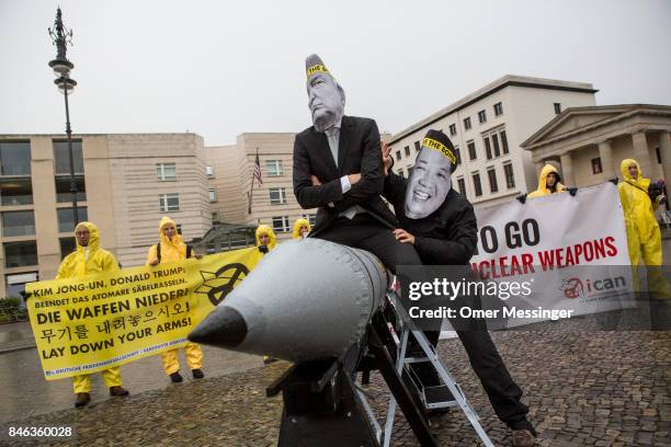 International campaign to abolish Nuclear Weapons activists wearing masks to look like US President Donald Trump and North Korean Kim Jong-Un pose...