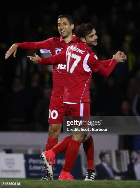 Nikola Mileusnic of Adelaide United is congratulated by Karim Matmour after scoring a goal during the FFA Cup Quarter Final match between Heidelberg...
