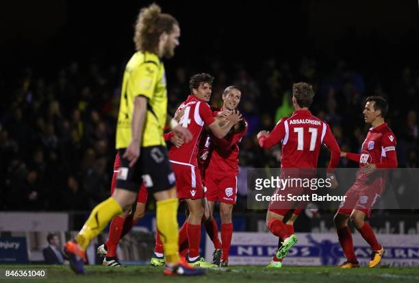 Nikola Mileusnic of Adelaide United is congratulated by his teammates after scoring a goal during the FFA Cup Quarter Final match between Heidelberg...