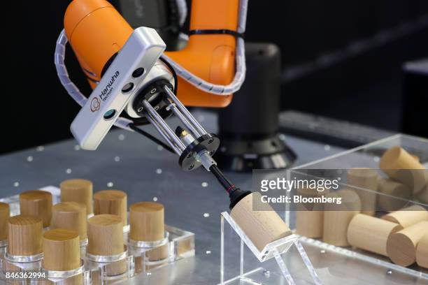Hanwha Techwin Co. Robotic arm transports pieces of wood during a demonstration at the RobotWorld 2017 industry show in Goyang, South Korea, on...
