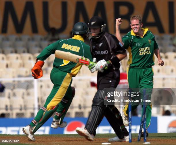 South Africa's Shaun Pollock celebrates with wicketkeeper Mark Boucher after taking the wicket of New Zealand's Lou Vincent during a match in the ICC...