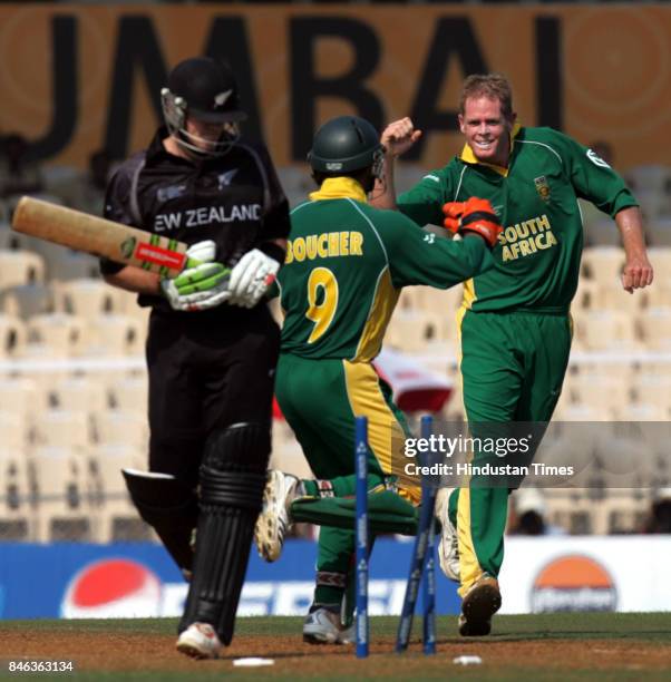 South Africa's Shaun Pollock celebrates with wicketkeeper Mark Boucher after taking the wicket of New Zealand's Lou Vincent during a match in the ICC...