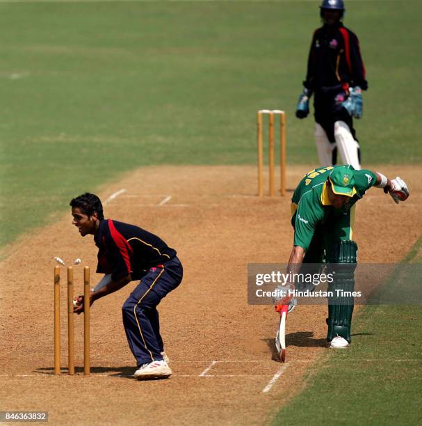 Mumbai Circket team bowler Iqbal Abdulla makes successful attempt to run out South Africas Kemp Justin during a practice match against the Mumabi...