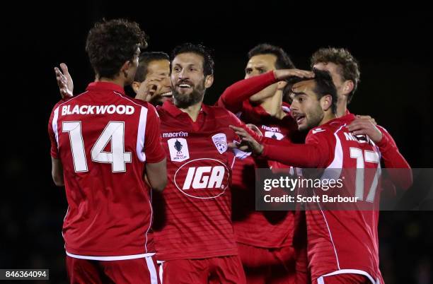 Nikola Mileusnic of Adelaide United is congratulated by his teammates after scoring his second goal during the FFA Cup Quarter Final match between...