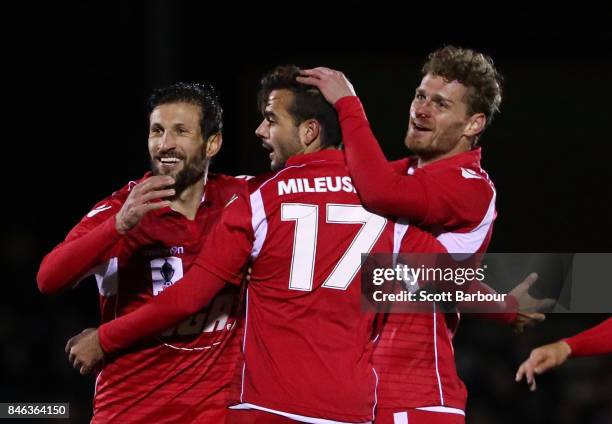 Nikola Mileusnic of Adelaide United is congratulated by his teammates after scoring his second goal during the FFA Cup Quarter Final match between...