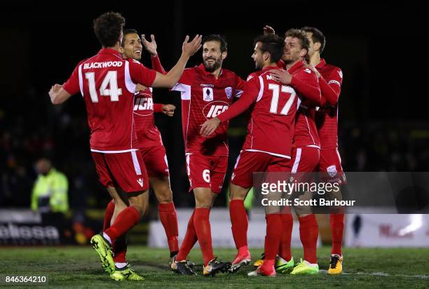 Nikola Mileusnic of Adelaide United is congratulated by his teammates after scoring his second goal during the FFA Cup Quarter Final match between...