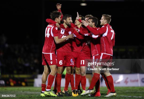 Nikola Mileusnic of Adelaide United is congratulated by his teammates after scoring his second goal during the FFA Cup Quarter Final match between...