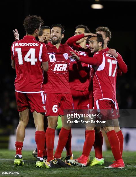 Nikola Mileusnic of Adelaide United is congratulated by his teammates after scoring his second goal during the FFA Cup Quarter Final match between...