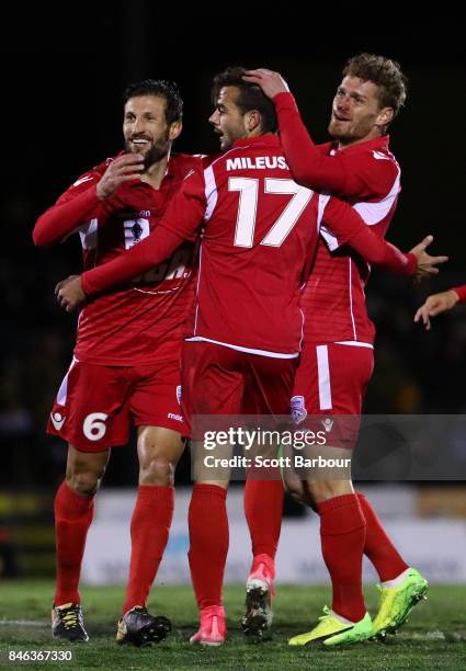 Nikola Mileusnic of Adelaide United is congratulated by his teammates after scoring his second goal during the FFA Cup Quarter Final match between...