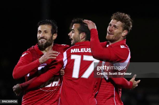 Nikola Mileusnic of Adelaide United is congratulated by his teammates after scoring his second goal during the FFA Cup Quarter Final match between...