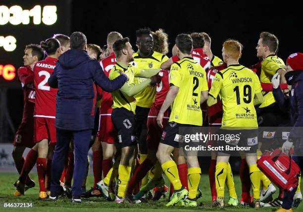 Jack Petrie of Heidelberg United FC and Vince Lia of Adelaide United confront each other as players argue during the FFA Cup Quarter Final match...