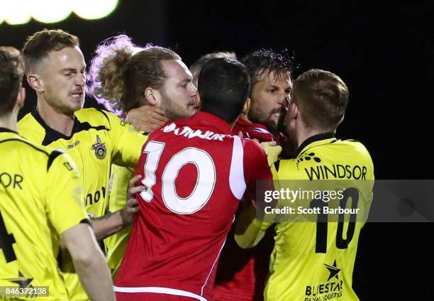 Jack Petrie of Heidelberg United FC and Vince Lia of Adelaide United confront each other as players argue during the FFA Cup Quarter Final match...