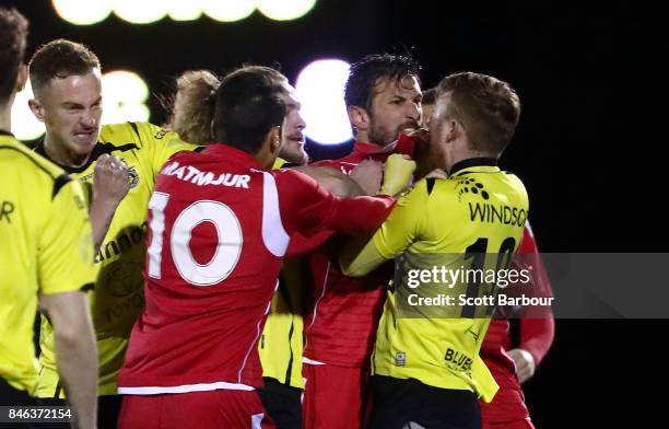 Jack Petrie of Heidelberg United FC and Vince Lia of Adelaide United confront each other as players argue during the FFA Cup Quarter Final match...