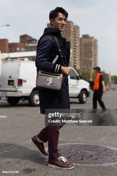 Xu Weizhou is seen attending Coach during New York Fashion Week wearing a navy coat on September 12, 2017 in New York City.