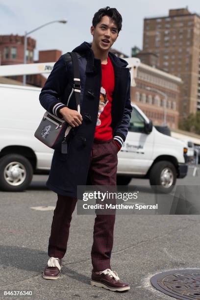 Xu Weizhou is seen attending Coach during New York Fashion Week wearing a navy coat on September 12, 2017 in New York City.