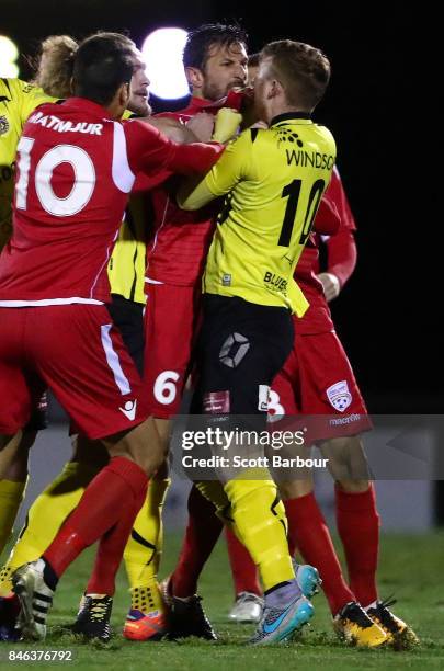 Jack Petrie of Heidelberg United FC and Vince Lia of Adelaide United confront each other as players argue during the FFA Cup Quarter Final match...