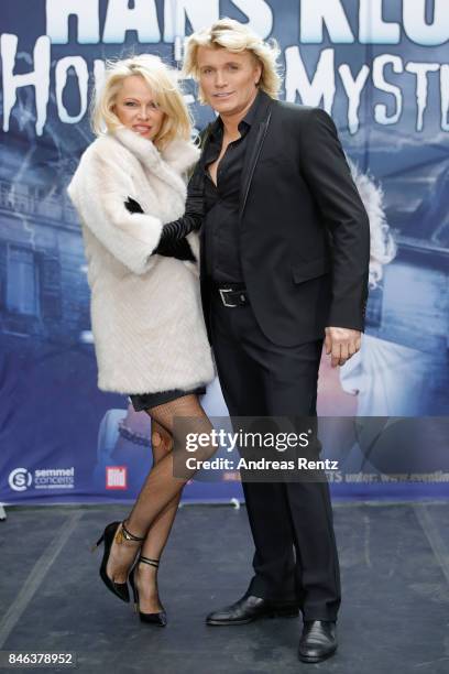 Illusionist Hans Klok and Pamela Anderson attend a photocall for their upcoming show 'House of Mystery' on September 13, 2017 in Cologne, Germany.