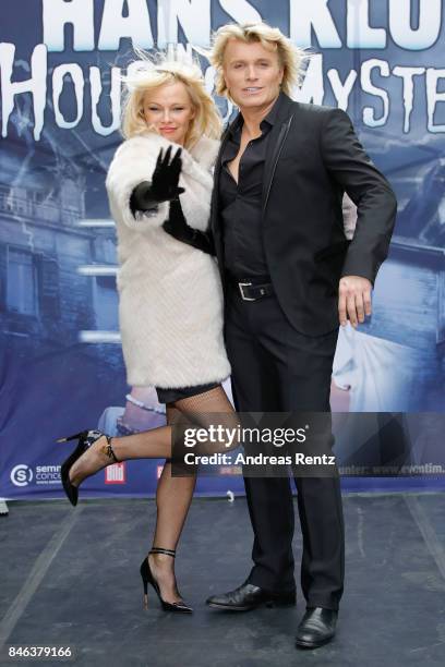 Illusionist Hans Klok and Pamela Anderson attend a photocall for their upcoming show 'House of Mystery' on September 13, 2017 in Cologne, Germany.