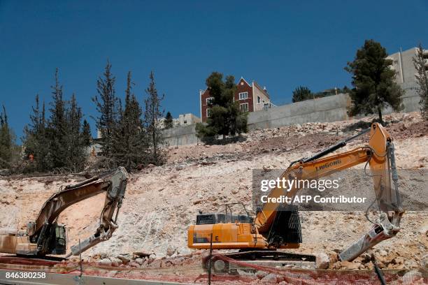 Diggers are seen on action in Ramat Shlomo, a Jewish settlement in the mainly Arab eastern sector of Jerusalem, on September 13, 2017. Israeli...