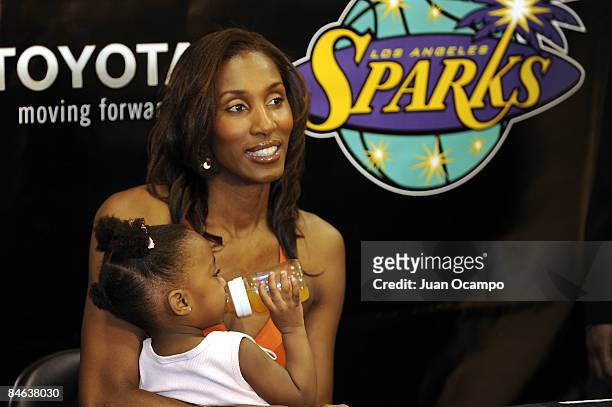 Los Angeles Sparks center Lisa Leslie holds her daughter Lauren, before a press conference announcing her retirement at the end of the 2009 WNBA...