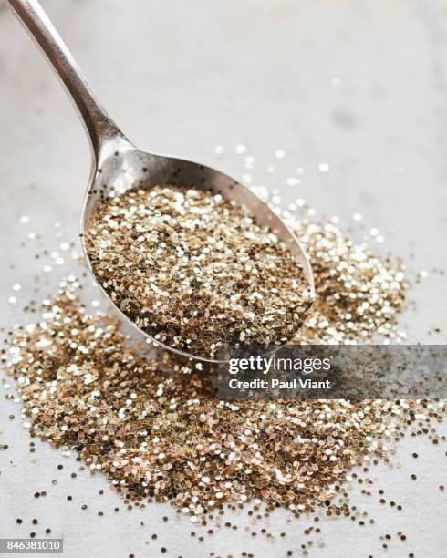 silver spoon and gold glitter - silver spoon in mouth stock pictures, royalty-free photos & images