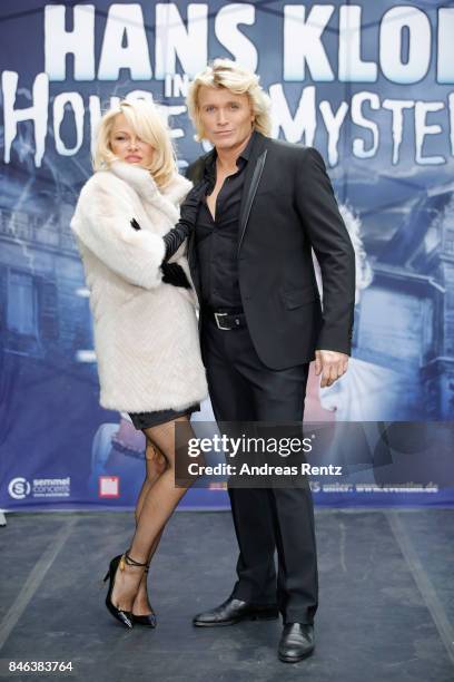 Illusionist Hans Klok and Pamela Anderson attend a photocall for their upcoming show 'House of Mystery' on September 13, 2017 in Cologne, Germany.