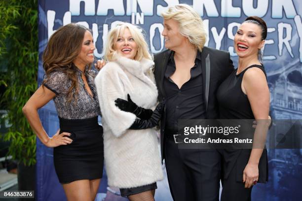 Illusionist Hans Klok and Pamela Anderson and their assistants attend a photocall for their upcoming show 'House of Mystery' on September 13, 2017 in...