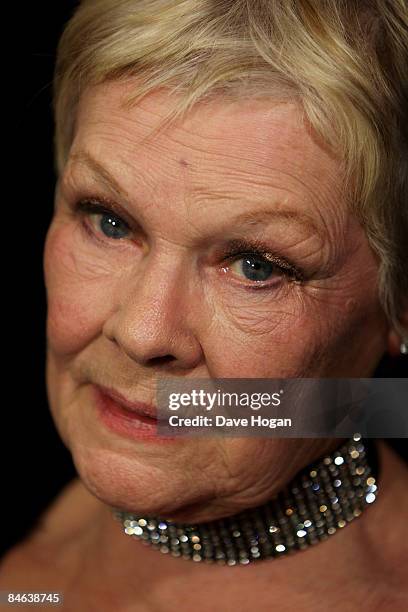 Judi Dench poses with her 'award for outstanding contribution to cinema' in the winners room at the London Critics' Circle Film Awards held at the...