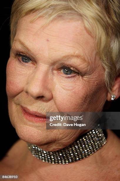 Judi Dench poses with her 'award for outstanding contribution to cinema' in the winners room at the London Critics' Circle Film Awards held at the...