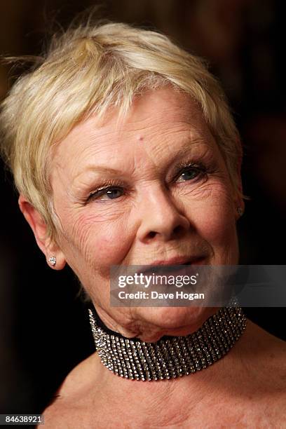 Judi Dench poses with her 'award for outstanding contribution to cinema' in the winners room at the London Critics' Circle Film Awards held at the...