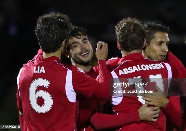 Nikola Mileusnic of Adelaide United is congratulated by his teammates after scoring his third goal during the FFA Cup Quarter Final match between...