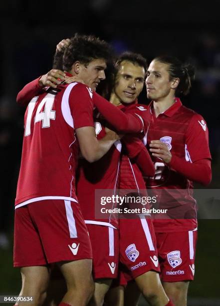 Nikola Mileusnic of Adelaide United is congratulated by his teammates after scoring his third goal during the FFA Cup Quarter Final match between...