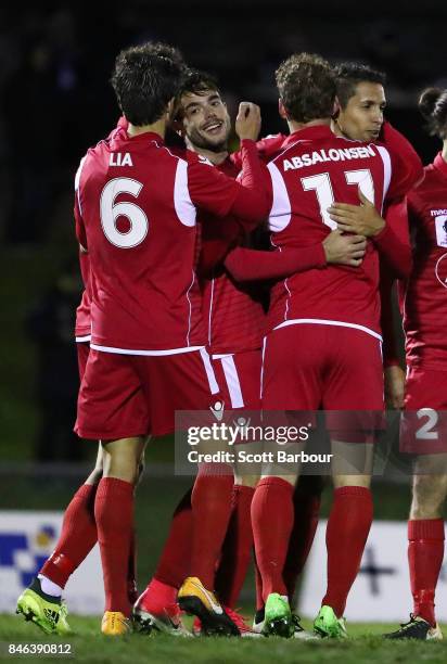 Nikola Mileusnic of Adelaide United is congratulated by his teammates after scoring his third goal during the FFA Cup Quarter Final match between...