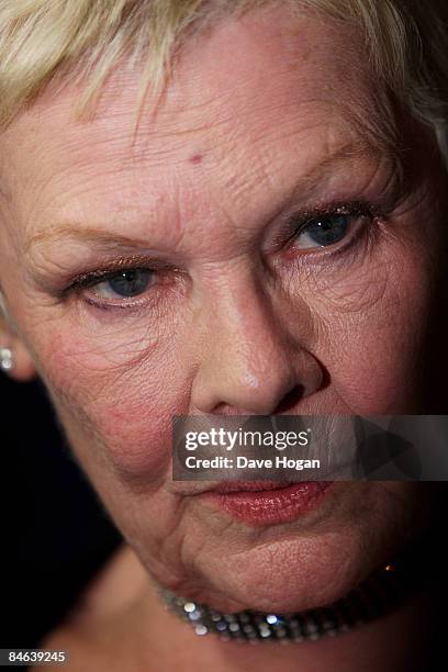 Judi Dench poses with her 'award for outstanding contribution to cinema' in the winners room at the London Critics' Circle Film Awards held at the...