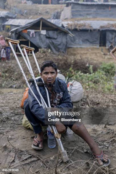 Rohingya man holds onto a pair of crutches at a newly set-up refugee camp at Balukhali in Cox's Bazar, Bangladesh, on Tuesday, Sept. 12, 2017....