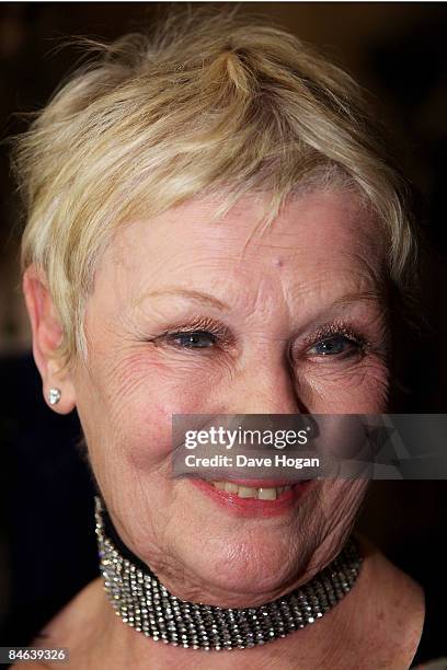 Judi Dench poses with her 'award for outstanding contribution to cinema' in the winners room at the London Critics' Circle Film Awards held at the...