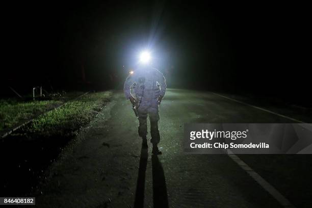 Florida Army National Guard Captain Adam Cockrell of Delta Company, 1st Battallion, 124th Infantry, 53rd Infantry Brigade Combat Team searches for an...