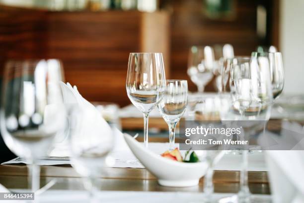 close up shot of restaurant table setup - glas serviesgoed stockfoto's en -beelden