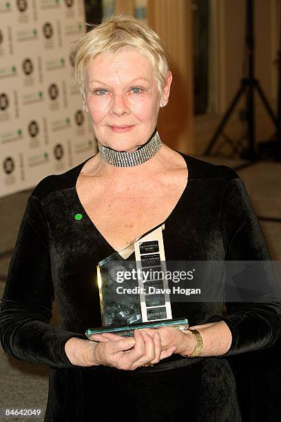 Dame Judi Dench poses with her 'outstanding contribution to cinema' award in the winners room at the London Critics' Circle Film Awards held at the...