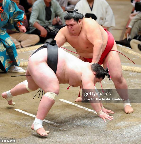 Onosho throws Monogolian ozeki Terunofuji to win during day four of the Grand Sumo Autumn Tournament at Ryogoku Kokugikan on September 13, 2017 in...