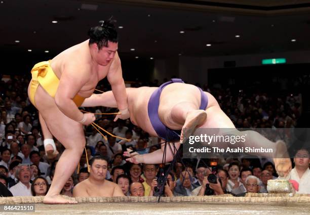 Endo throws Yutakayama to win during day four of the Grand Sumo Autumn Tournament at Ryogoku Kokugikan on September 13, 2017 in Tokyo, Japan.