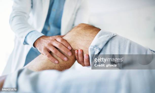 senior man having medical exam. - limb body part stock pictures, royalty-free photos & images