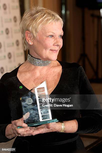 Dame Judi Dench poses with her 'outstanding contribution to cinema' award in the winners room at the London Critics' Circle Film Awards held at the...