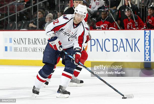 Michael Nylander of the Washington Capitals controls the puck against the New Jersey Devils at the Prudential Center on February 3, 2009 in Newark,...