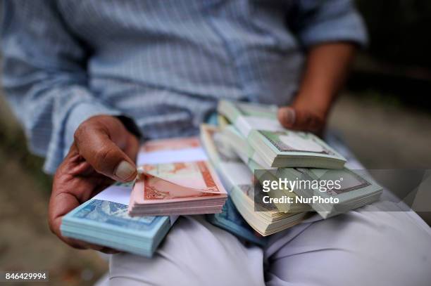 Yrs old, Bhairab Lal Suwal, shows new notes, after exchange from the Nepal Rastra Bank for the Biggest Dashain Festival in Kathmandu on Wednesday,...
