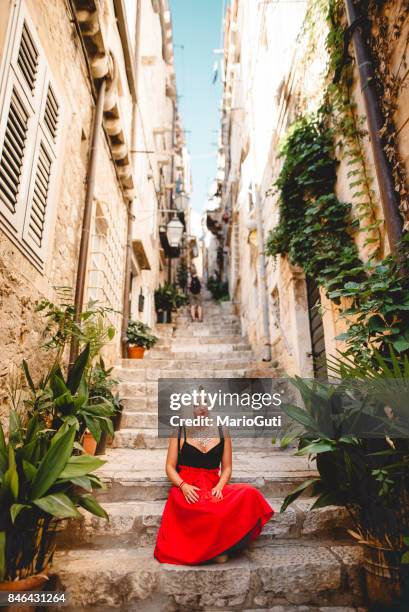 young woman sitting in a dubrovnik street - dubrovnik old town stock pictures, royalty-free photos & images