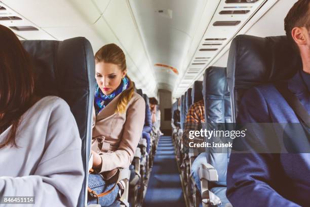 passengers on seat during flight - dentro imagens e fotografias de stock