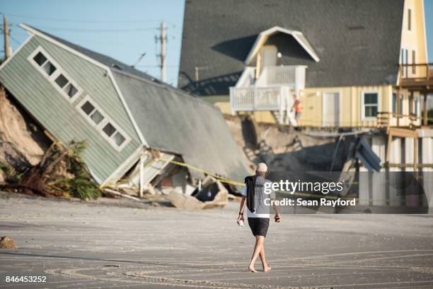 Man walks by a beachfront home destroyed by Hurricane Irma on September 13, 2017 in Vilano Beach, Florida. Nearly 4 million people remained without...