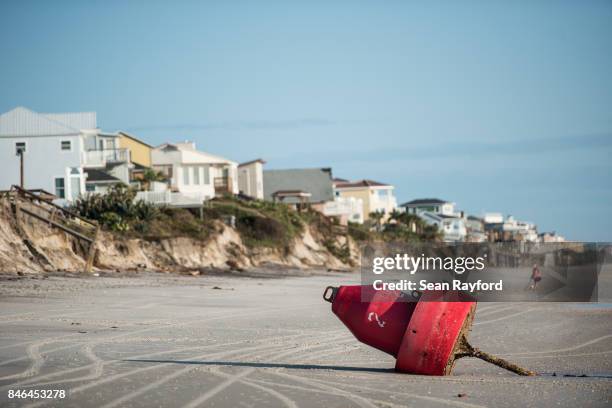 Buoy sits on an eroded beach caused by Hurricane Irma on September 13, 2017 in Vilano Beach, Florida. Nearly 4 million people remained without power...